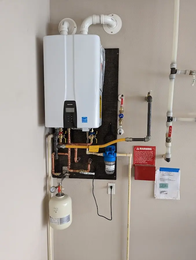 Professional plumber installing copper piping in a Bluefield home